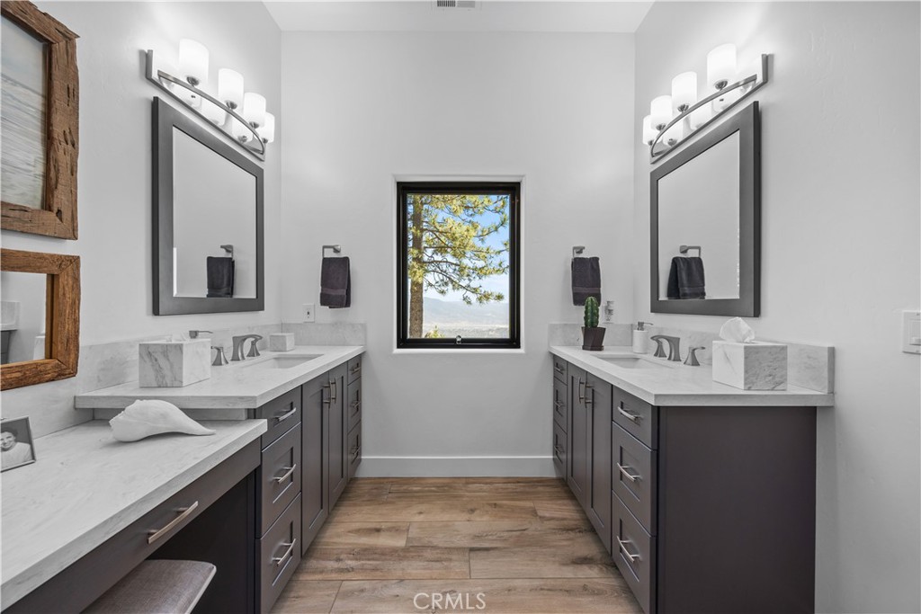 27300 Stirrup Way Tehachapi, CA 93561 - Photo 24 of 45 a bathroom with a double vanity sink mirror and