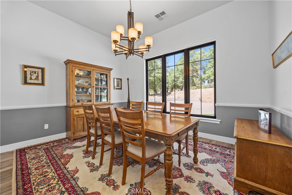 27300 Stirrup Way Tehachapi, CA 93561 - Photo 30 of 45 a view of a dining room with furniture a chandelier and wooden floor