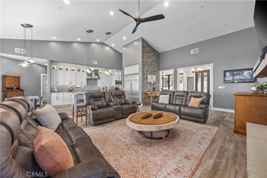 27300 Stirrup Way Tehachapi, CA 93561 - Photo 34 of 45 a living room with furniture a rug and a chandelier