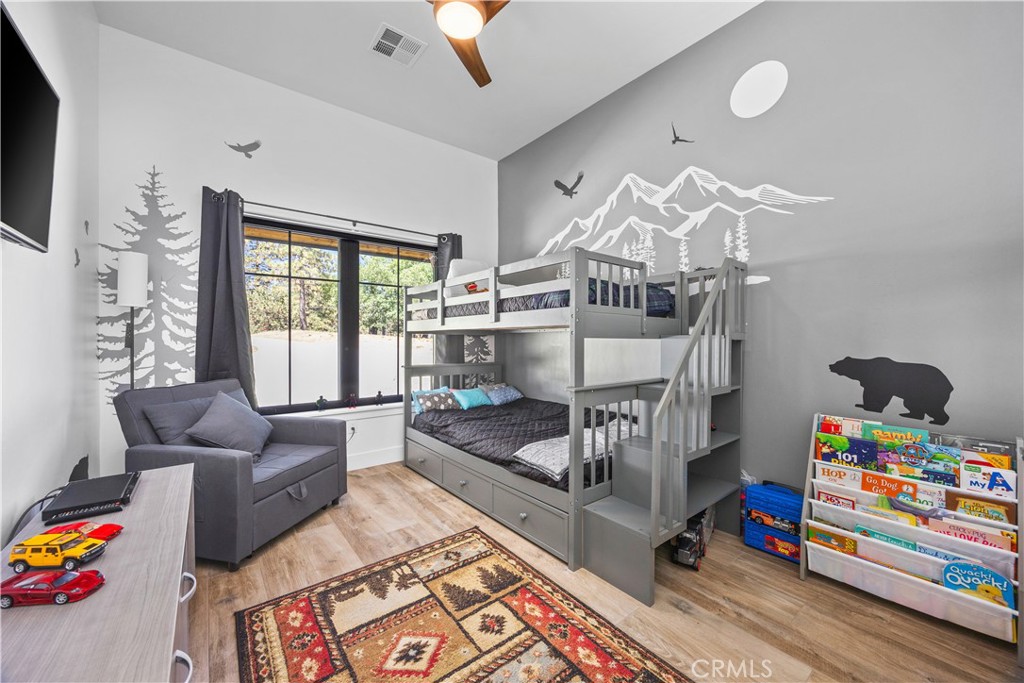 27300 Stirrup Way Tehachapi, CA 93561 - Photo 35 of 45 a bedroom with furniture and a wooden floor