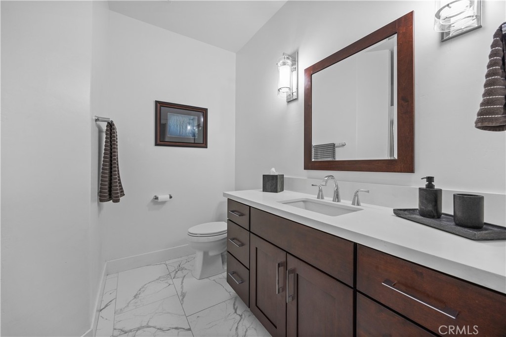 27300 Stirrup Way Tehachapi, CA 93561 - Photo 39 of 45 a bathroom with a toilet sink and mirror