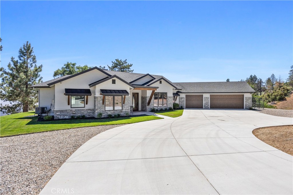 27300 Stirrup Way Tehachapi, CA 93561 - Photo 5 of 45 a front view of a house with a yard and garage