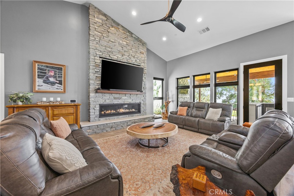 27300 Stirrup Way Tehachapi, CA 93561 - Photo 9 of 45 a living room with fireplace furniture and a flat screen tv