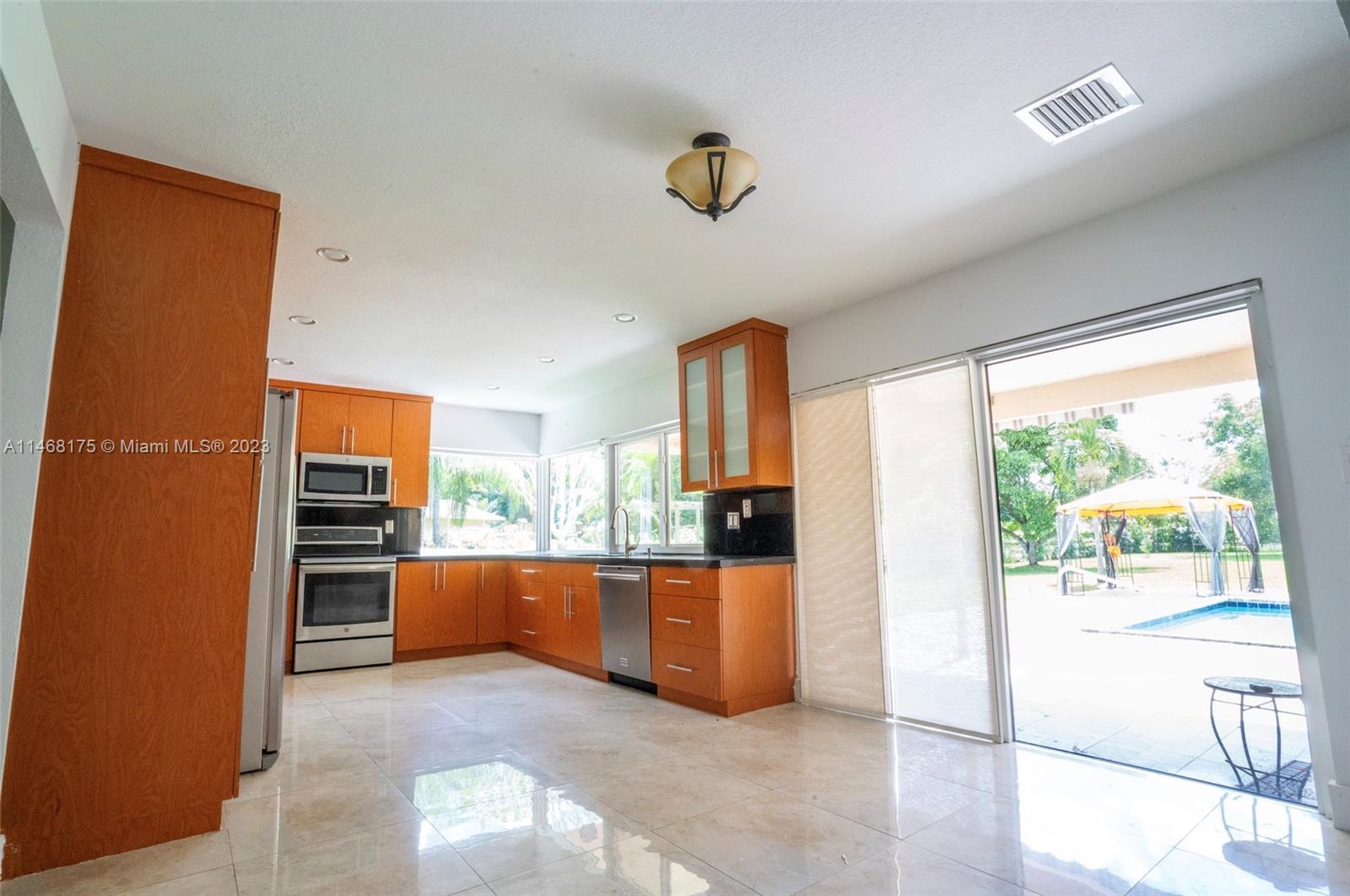 18520 Southwest 58th Street Southwest Ranches, FL 33332 - Photo 6 of 20 a view of a kitchen with a sink and a refrigerator
