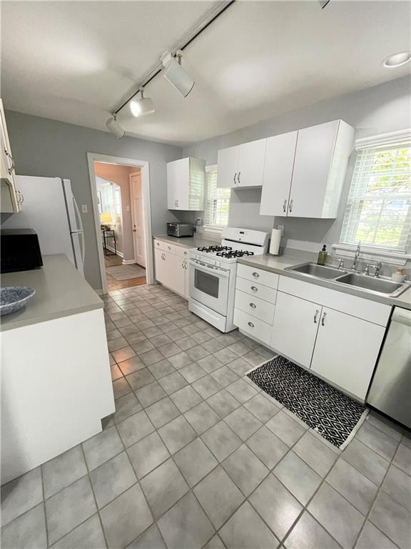 138 Mohawk Drive Pittsburgh, PA 15228 - Photo 5 of 24 a kitchen with stainless steel appliances a sink a stove a refrigerator cabinets and a window