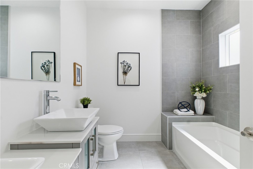 1364 Ridgeley Drive Los Angeles, CA 90019 - Photo 11 of 25 a white bath tub sitting next to a white toilet