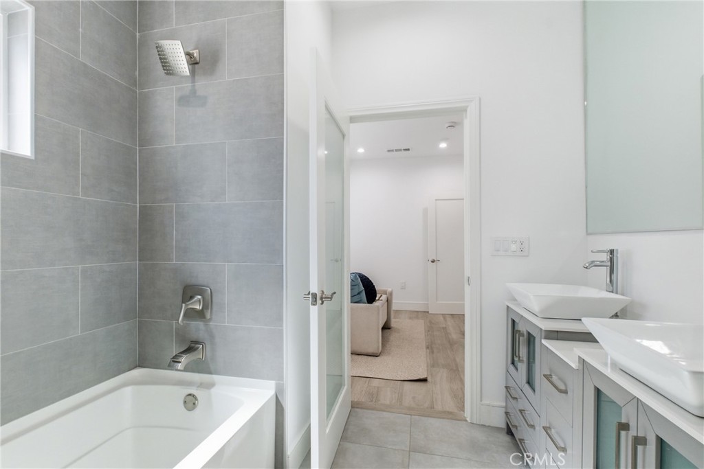 1364 Ridgeley Drive Los Angeles, CA 90019 - Photo 12 of 25 a bathroom with a tub sink and mirror