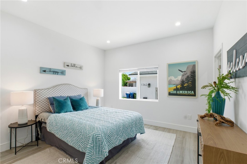 1364 Ridgeley Drive Los Angeles, CA 90019 - Photo 13 of 25 a bedroom with a bed table and a window
