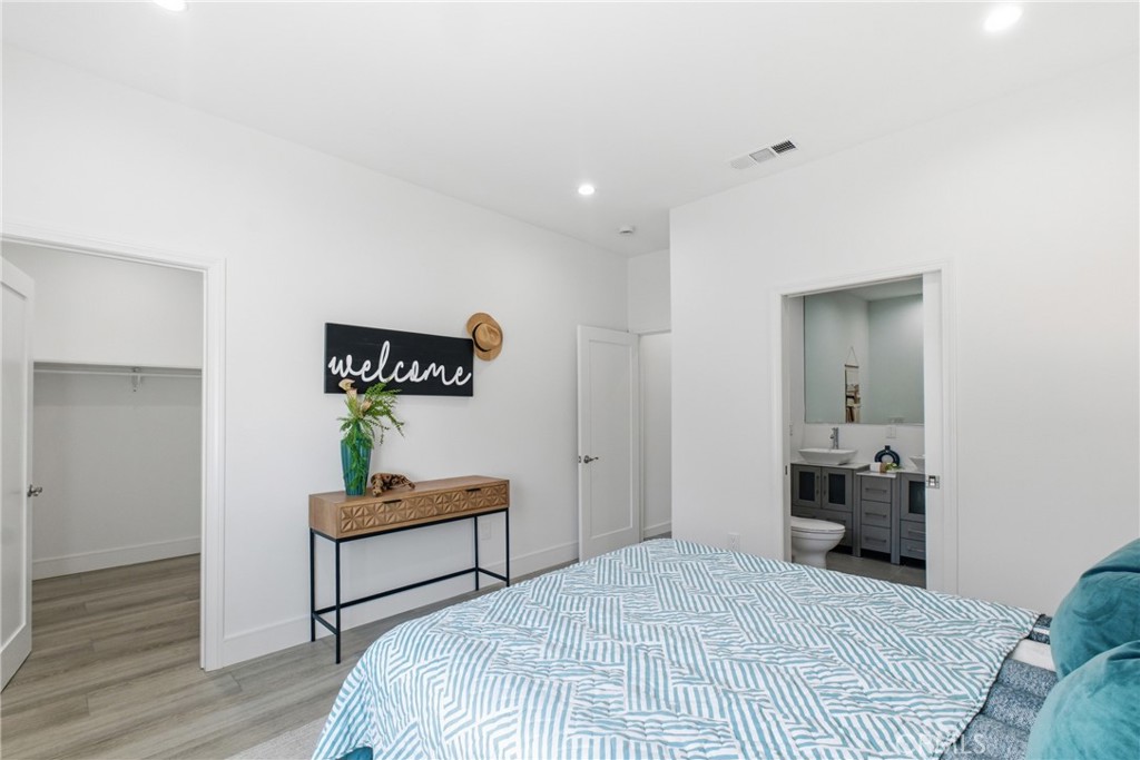 1364 Ridgeley Drive Los Angeles, CA 90019 - Photo 14 of 25 a bedroom with a bed and a lamp