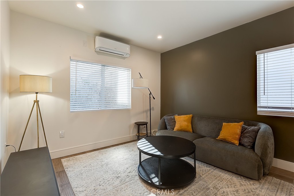 1364 Ridgeley Drive Los Angeles, CA 90019 - Photo 18 of 25 a living room with furniture and a window