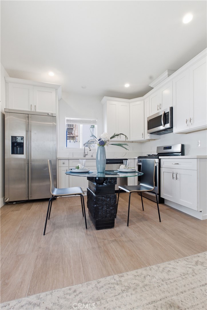 1364 Ridgeley Drive Los Angeles, CA 90019 - Photo 19 of 25 a living room with stainless steel appliances kitchen island granite countertop furniture and a couch