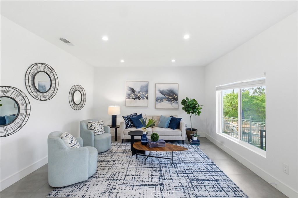 1364 Ridgeley Drive Los Angeles, CA 90019 - Photo 2 of 25 a living room with furniture and a rug