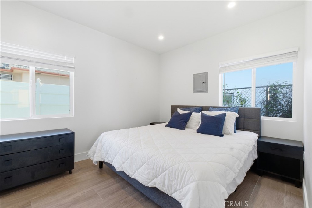 1364 Ridgeley Drive Los Angeles, CA 90019 - Photo 21 of 25 a large bed sitting in a bedroom next to a window