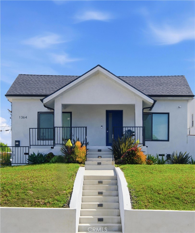 1364 Ridgeley Drive Los Angeles, CA 90019 - Photo 24 of 25 a front view of a house with garden