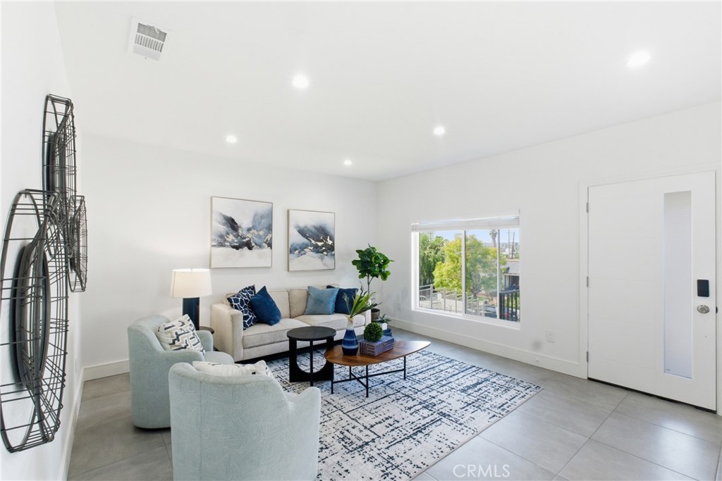 1364 Ridgeley Drive Los Angeles, CA 90019 - Photo 4 of 25 a living room with furniture and a window