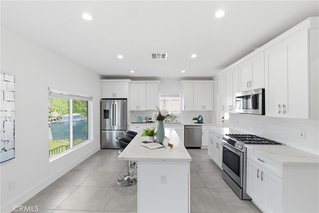 1364 Ridgeley Drive Los Angeles, CA 90019 - Photo 5 of 25 a kitchen with a stove a sink and a refrigerator