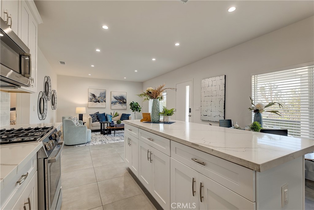 1364 Ridgeley Drive Los Angeles, CA 90019 - Photo 7 of 25 a kitchen with sink cabinets and window