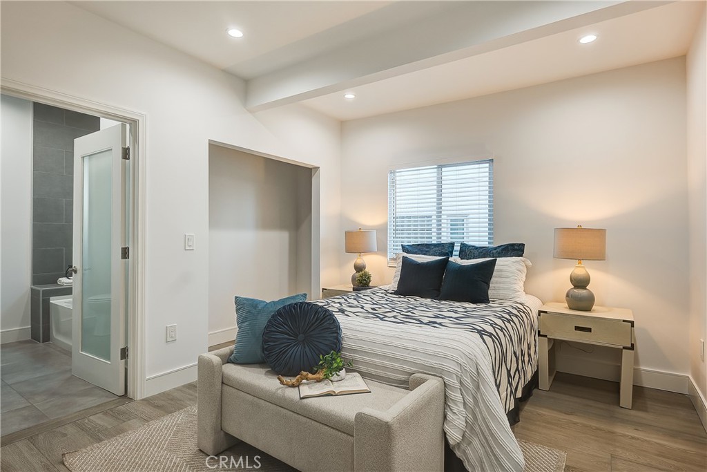 1364 Ridgeley Drive Los Angeles, CA 90019 - Photo 9 of 25 a bedroom with a bed and a mirror