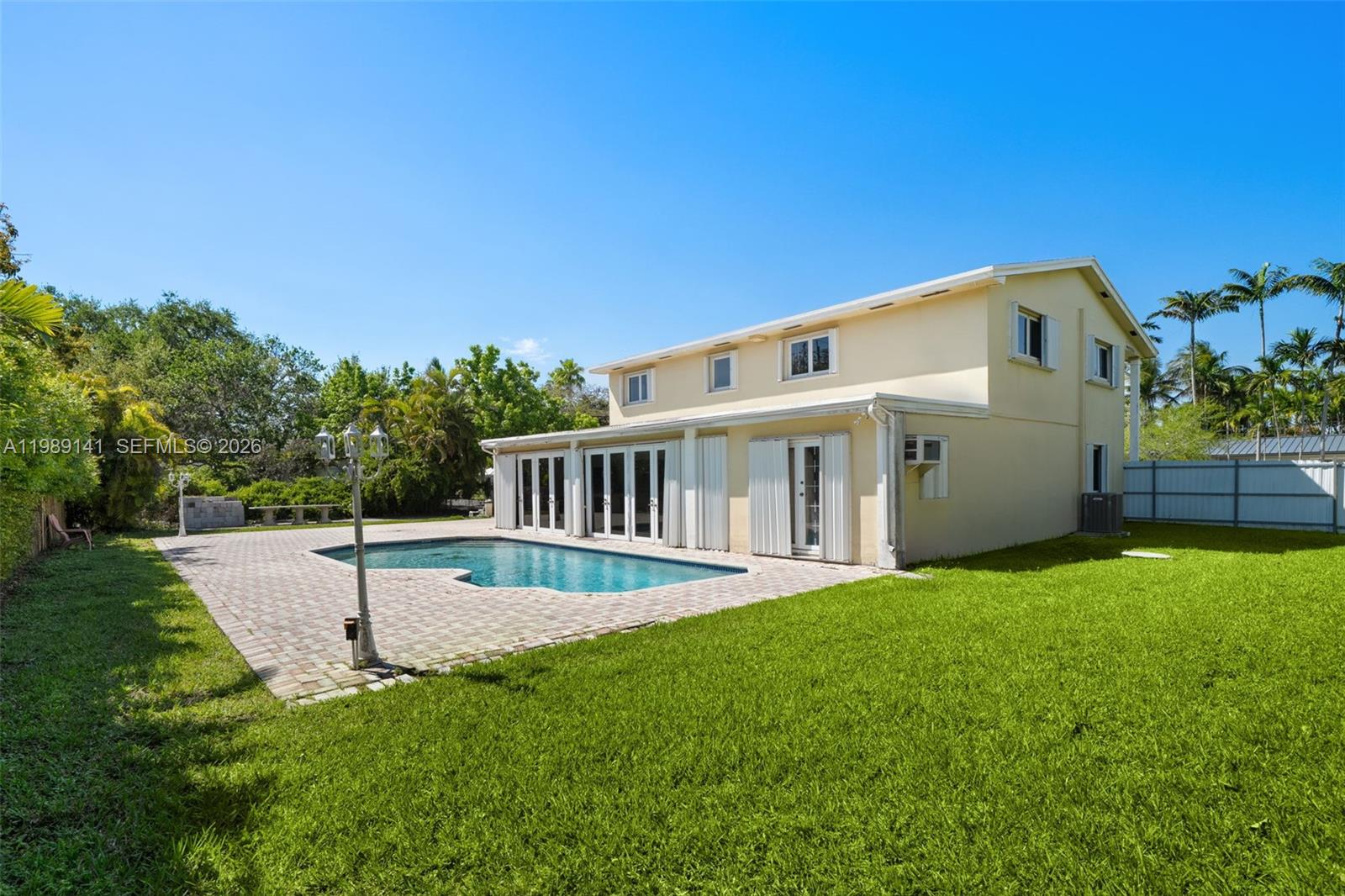 7390 Southwest 114th Street Pinecrest, FL 33156 - Photo 17 of 19 a view of house with backyard and garden