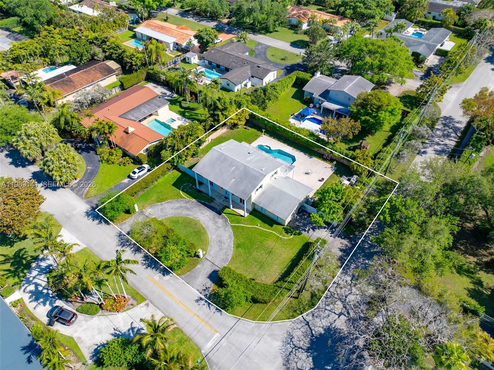 7390 Southwest 114th Street Pinecrest, FL 33156 - Photo 2 of 19 an aerial view of a house with a garden