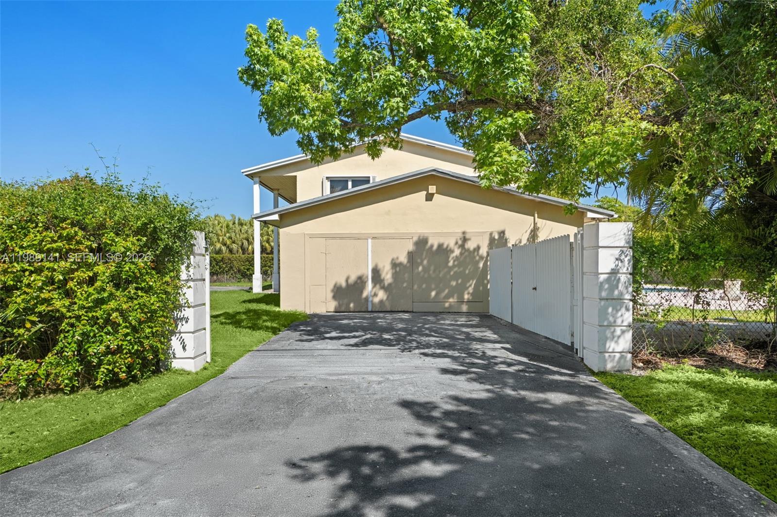 7390 Southwest 114th Street Pinecrest, FL 33156 - Photo 5 of 19 a view of a house with a yard