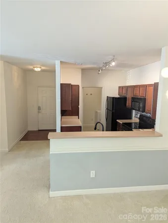 a view of a kitchen with two large window