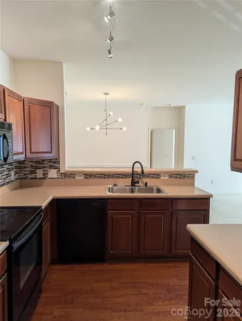 a kitchen with sink stove and cabinets
