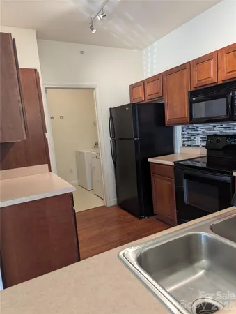 a kitchen with stainless steel appliances a refrigerator sink and stove