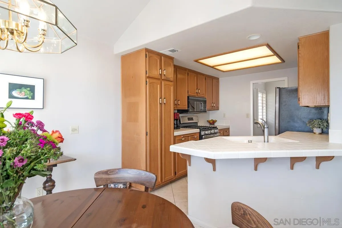 1237 Buttonwood Court El Cajon, CA 92019 - Photo 13 of 45 a dining room with furniture and a chandelier