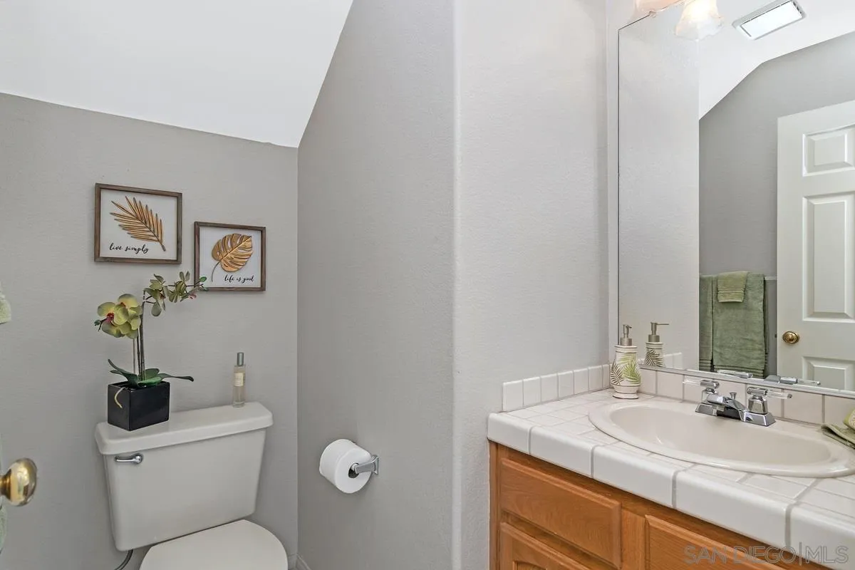 1237 Buttonwood Court El Cajon, CA 92019 - Photo 14 of 45 a bathroom with a toilet sink and mirror