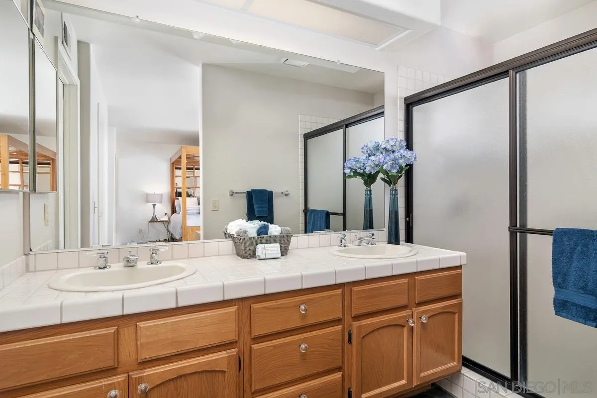 1237 Buttonwood Court El Cajon, CA 92019 - Photo 18 of 45 a bathroom with a granite countertop sink and a mirror