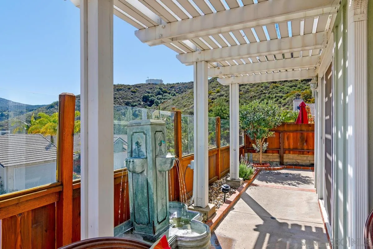 1237 Buttonwood Court El Cajon, CA 92019 - Photo 27 of 45 a view of a porch with furniture and floor to ceiling window
