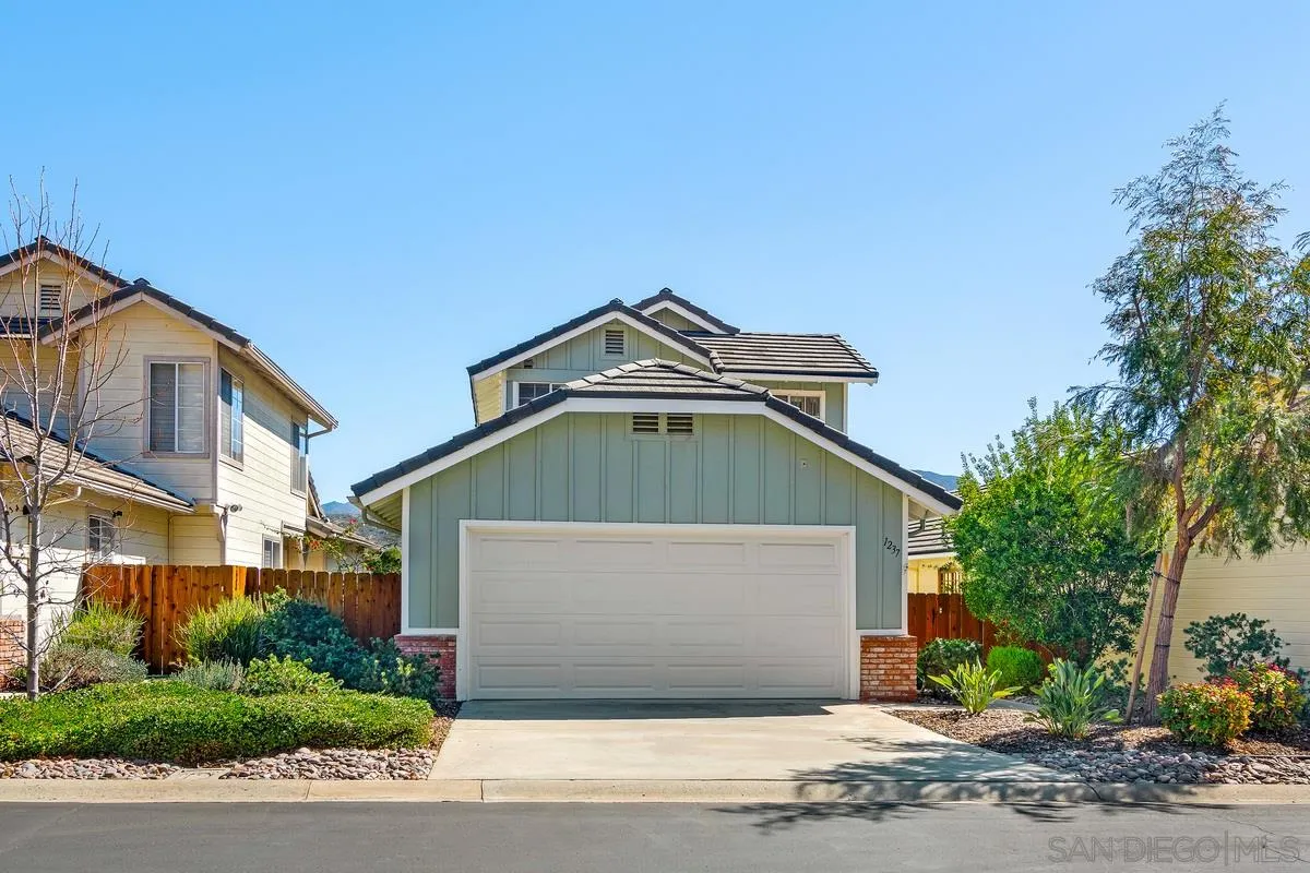 1237 Buttonwood Court El Cajon, CA 92019 - Photo 45 of 45 a front view of a house with a yard and garage