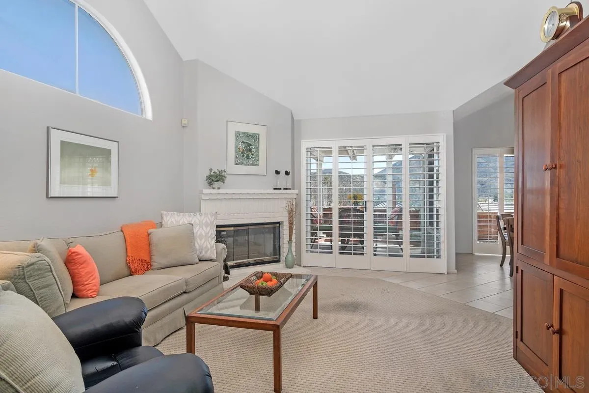 1237 Buttonwood Court El Cajon, CA 92019 - Photo 7 of 45 a living room with furniture a flat screen tv and a fireplace