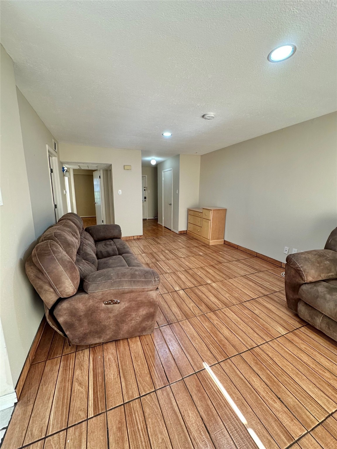 8245 Kingsbrook Road, Unit 236 Houston, TX 77024 - Photo 6 of 14 a large bedroom with a bed and wooden floor