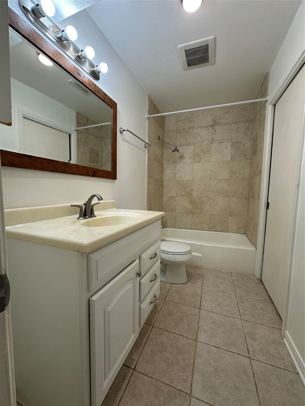 8245 Kingsbrook Road, Unit 236 Houston, TX 77024 - Photo 8 of 14 a bathroom with a sink a toilet a mirror and shower