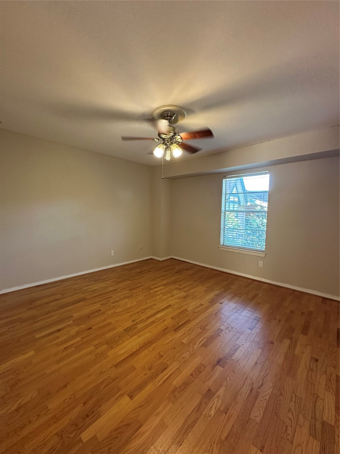 8245 Kingsbrook Road, Unit 236 Houston, TX 77024 - Photo 10 of 14 an empty room with wooden floor and windows
