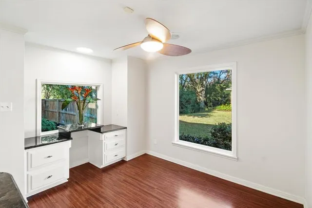 a bedroom with a bed and a large window with outer view