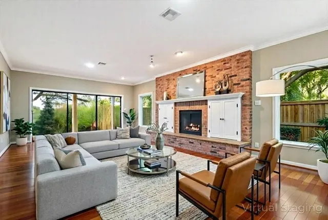 a living room with furniture fireplace and a large window