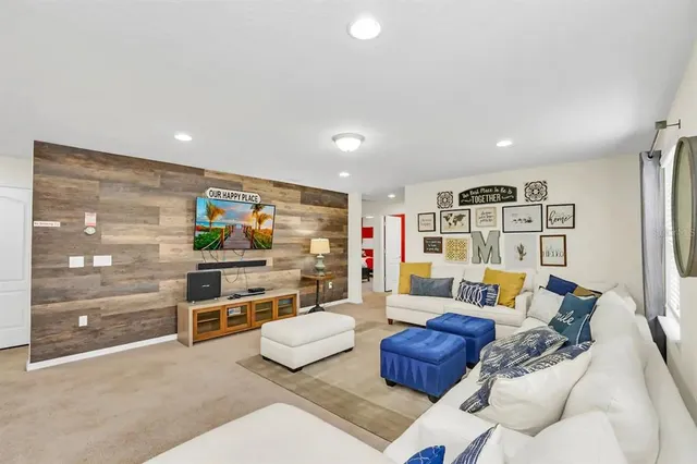 a living room with furniture and a bookshelf