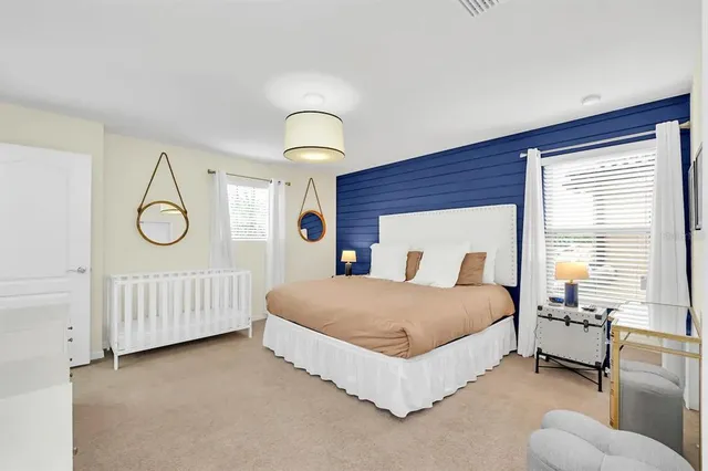 a spacious bedroom with a bed and a window