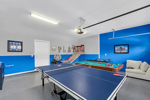 a room with furniture pool table and window