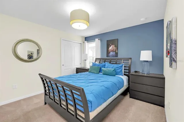 a bedroom with a bed and a chandelier