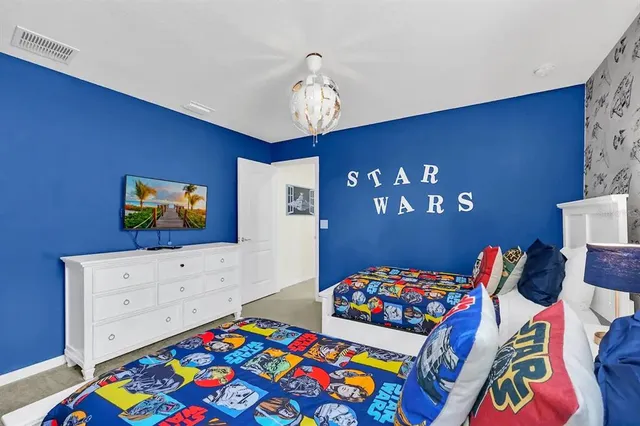 a bedroom with furniture and a lamp