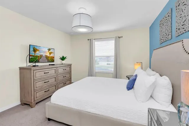 a bedroom with a bed and a chandelier