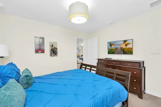 a bedroom with a bed and a chandelier