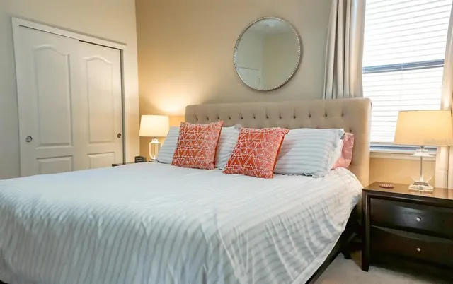 a bedroom with a bed and a window