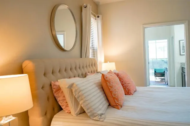a bedroom with a bed and a mirror