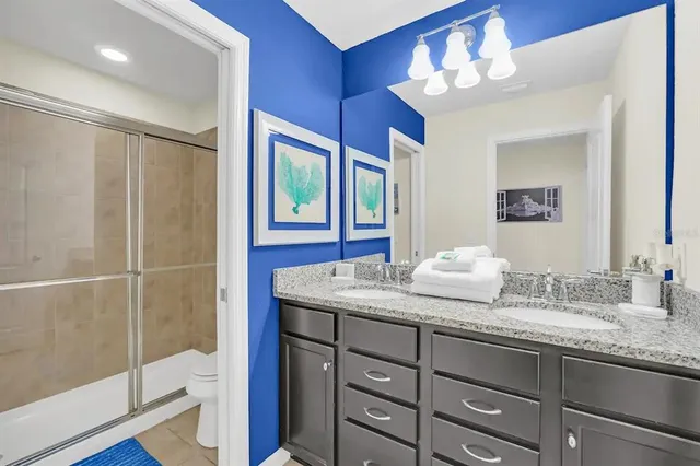 a bathroom with a granite countertop sink mirror and double