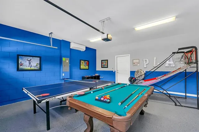 a room with pool table and windows